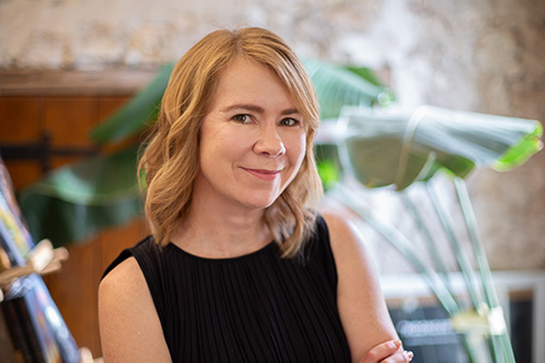 AJ Betts YA and Children's author with palm behind